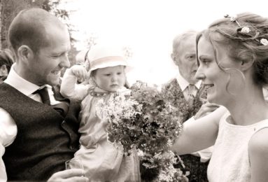 Bride-and-Groom-Cuddle-Their-Daughter